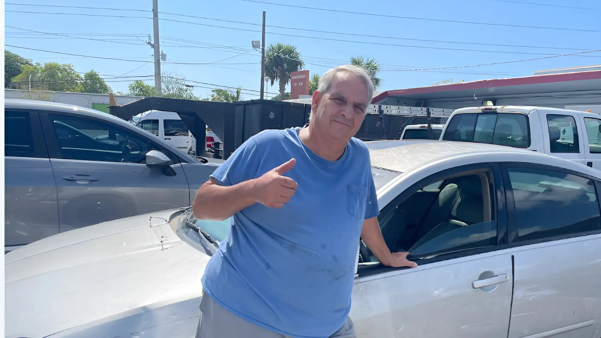 A man standing beside a car, representing a Junk Nissan Maxima Buyer in Pompano Beach.