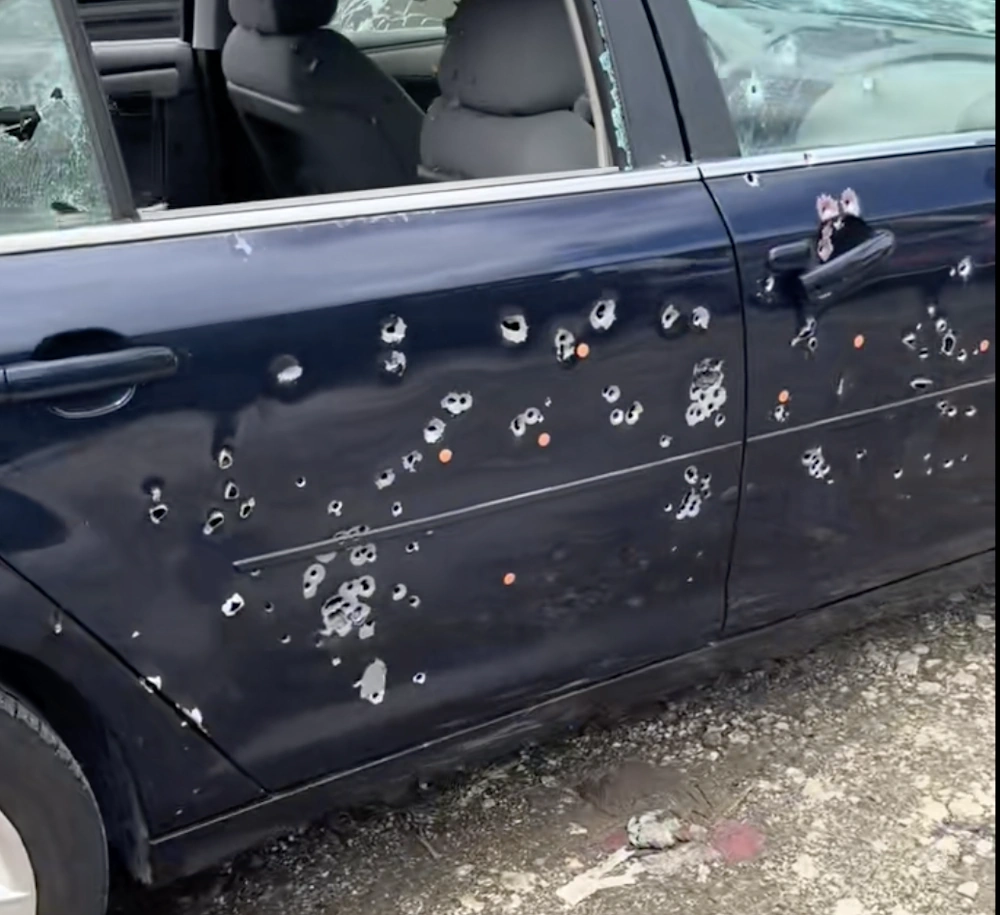 Car with bullet holes and shattered window representing Hercules' Cash for Cars Miami