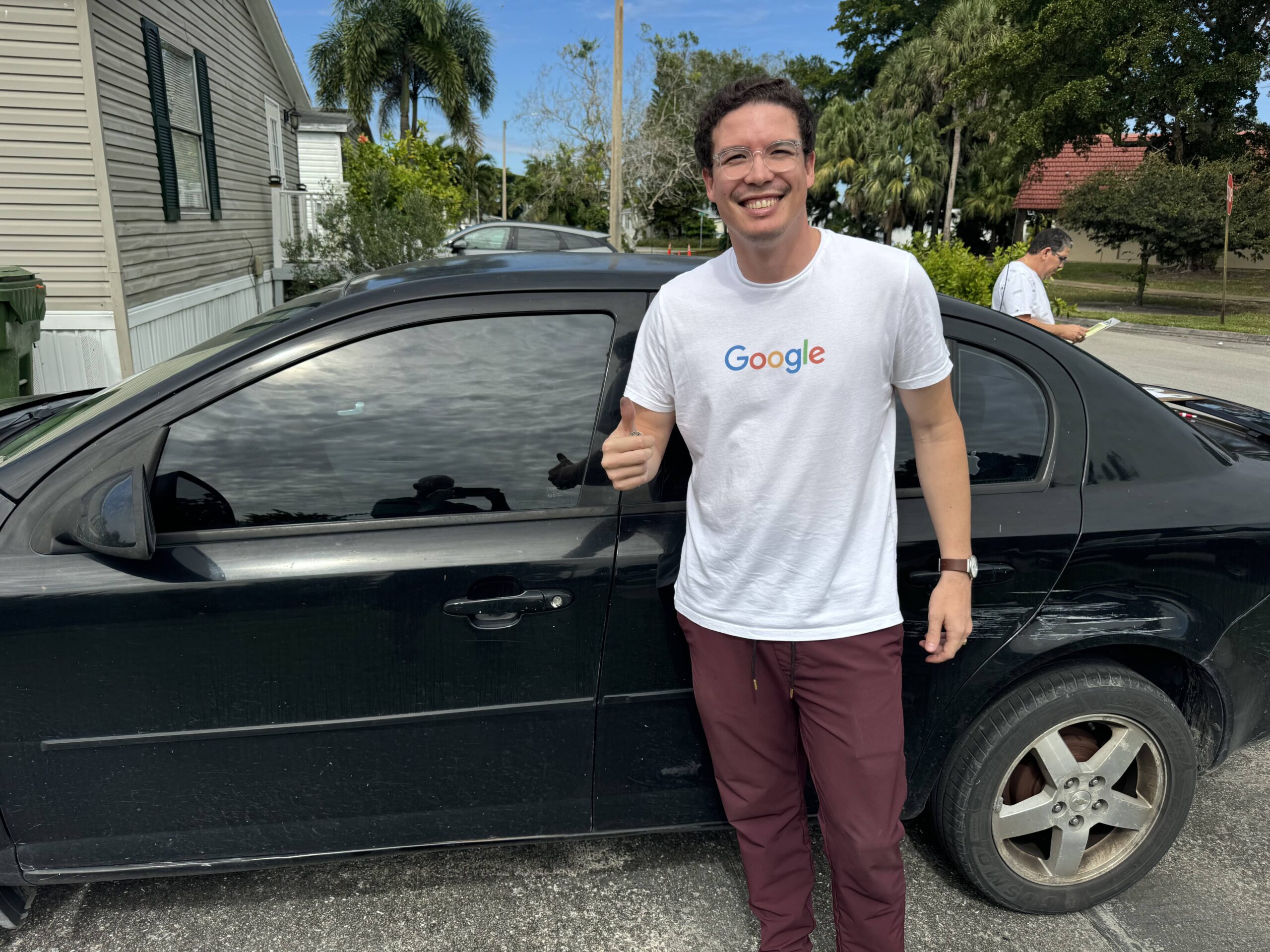 A man next to a car representing Hercules We Buy Junk Cars West Palm Beach