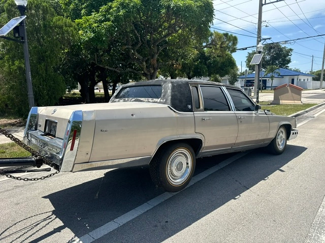 A vintage junk old car being towed